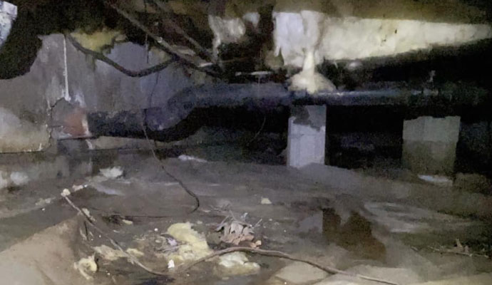 Severe water damage in muddy and flooded crawl space