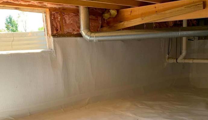 Crawl space ventilation ductwork and open vent window installed beneath floor joists