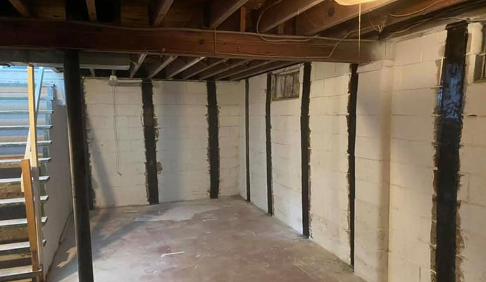 Carbon fiber foundation straps securing a foundation wall