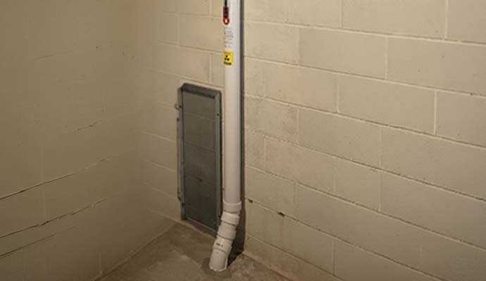 Radon vent pipe through basement floor