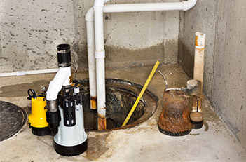 Old sump pump compared to a new sump pump